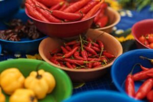 Assorted colorful chili peppers in bowls, perfect for spice and flavor photography.