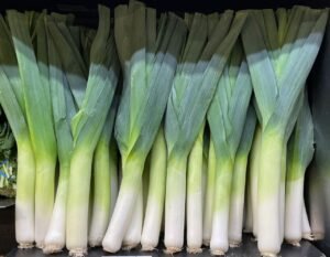 A vibrant display of fresh leeks neatly stacked, ideal for healthy cooking.