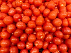 A close-up view of a pile of vibrant red tomatoes in Box Hill, Victoria.